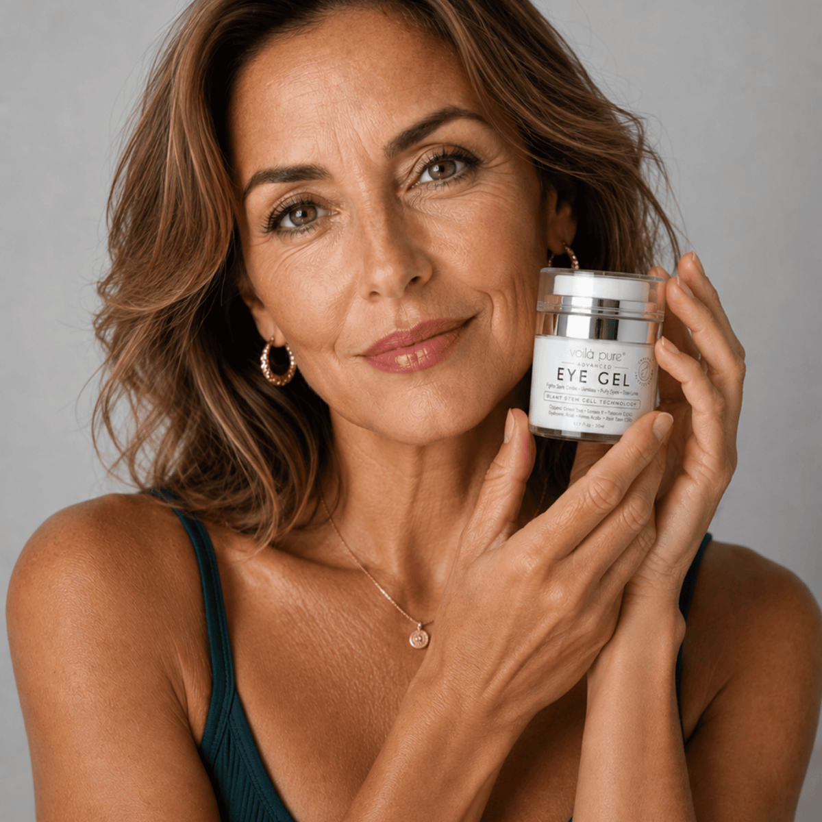 Woman holding a container of Voila Pure under-eye Gel