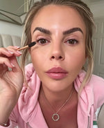 Customer applying lash serum to her lashes