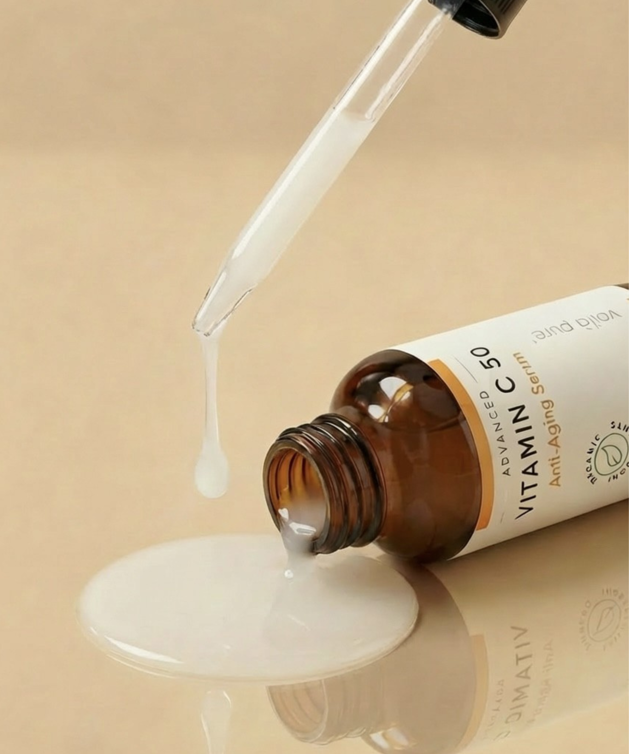 Vitamin C serum being dripped from a dropper onto a beige surface with a beige background.